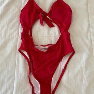 The cutest one piece!! Open back and front! Large but fits like medium!